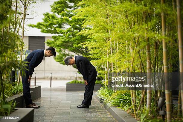 traditionelle japanische business-begrüßung - gutes benehmen stock-fotos und bilder