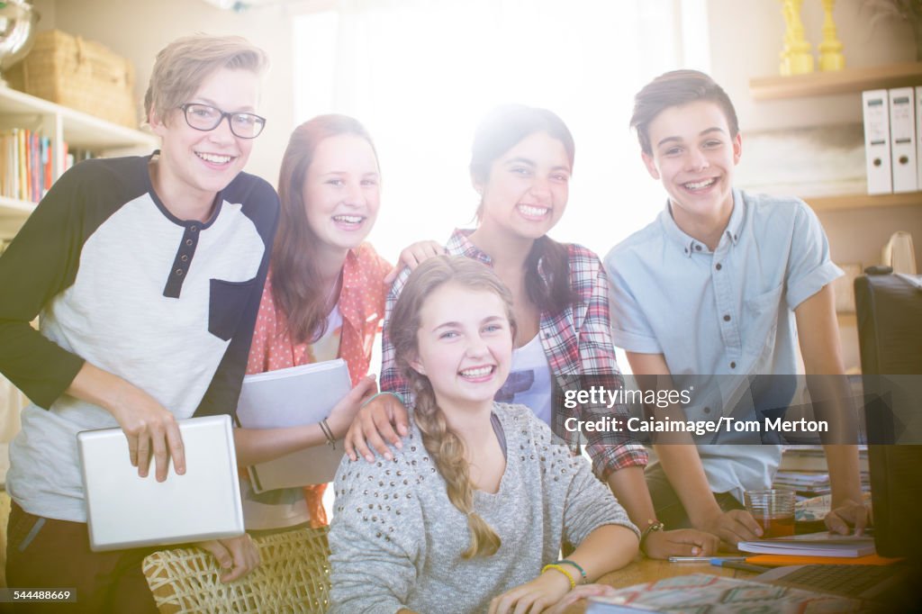 Group portrait of smiling teenagers at home