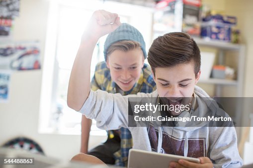Two teenage boys having fun while using digital tablet Two teenage boys having fun while using digital tablet