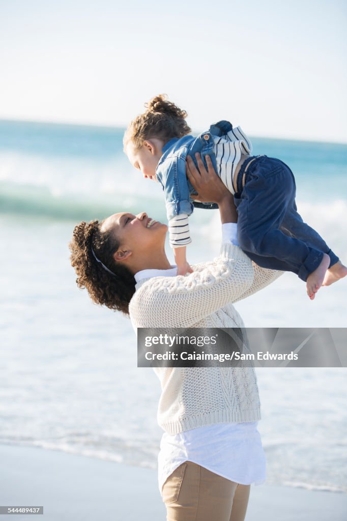 Mother and daughter playing on beach