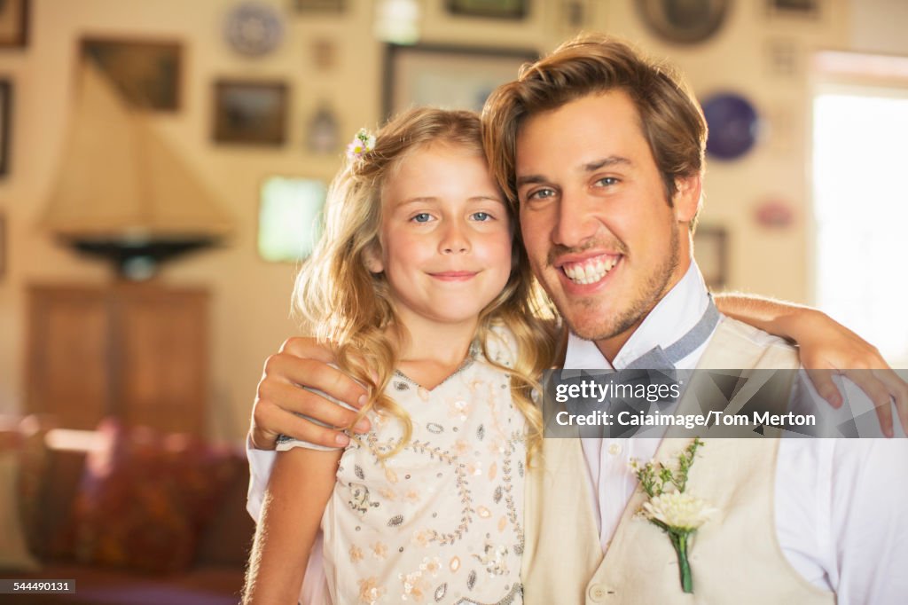 Portrait of bridegroom and bridesmaid in domestic room