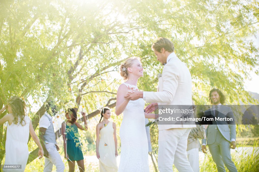 Young couple dancing at wedding reception in domestic garden