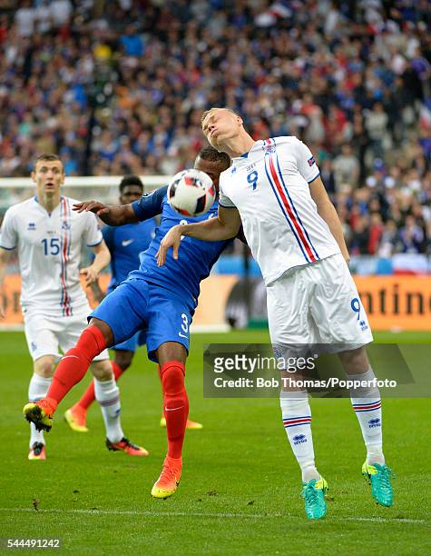 Kolbeinn Sigthorsson of Iceland heads the ball with Patrice Evra of France during the UEFA EURO 2016 quarter final match between France and Iceland...