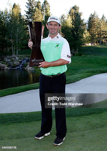 Greg Chalmers of Australia poses with the trophy during the final round of the Barracuda Championship at the Montreux Golf and Country Club on July...