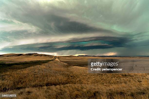 usa, montana, storm clouds above field - montana western usa stock-fotos und bilder