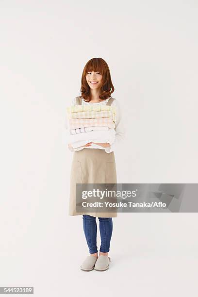 full length portrait of young japanese woman against white background - apron isolated stockfoto's en -beelden