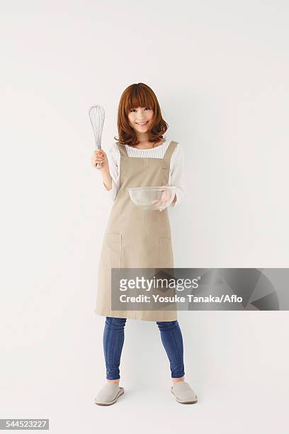 full length portrait of young japanese woman against white background - whipping woman stock pictures, royalty-free photos & images