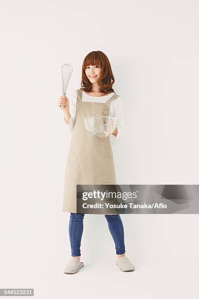 full length portrait of young japanese woman against white background - female whipping 個照片及圖片檔