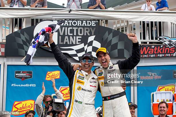 Joao Barbosa of Portugal and Christian Fittipaldi, of Brazil, celebrate after winning the IMSA WeatherTech Series race at Watkins Glen International...
