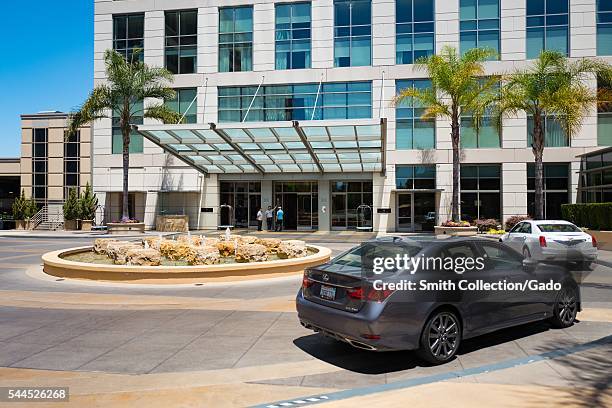 Cars pull into the entrance of the Four Seasons Hotel Silicon Valley on a sunny day, East Palo Alto, California, 2016. The hotel is a popular...