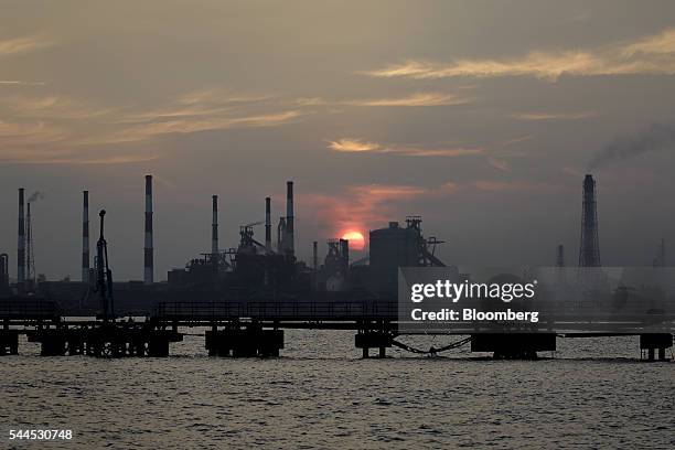 The sun sets behind the Mizushima coastal industrial complex in Kurashiki, Okayama Prefecture, Japan, on Friday, June 17, 2016. Starting on July 4,...