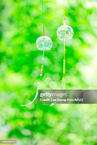 wind chimes in a park - shaking hangs stock pictures, royalty-free photos & images