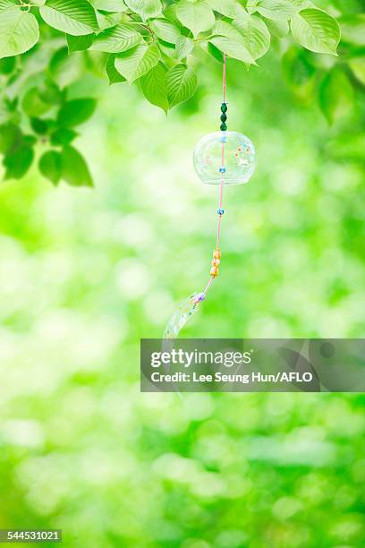 wind chime in a park - shaking hangs stock pictures, royalty-free photos & images