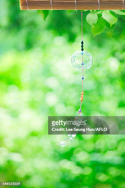 wind chime in a park - shaking hangs stock pictures, royalty-free photos & images