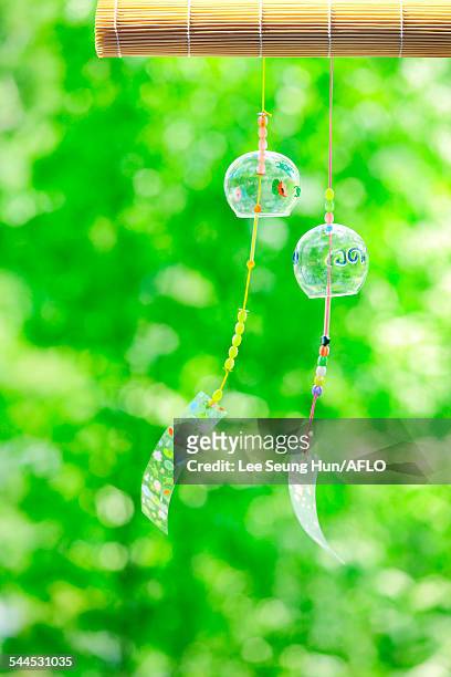 wind chimes in a park - shaking hangs stock pictures, royalty-free photos & images