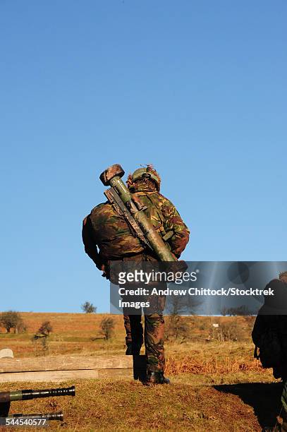 a british soldier with a matador light anti-tank weapon slung over his shoulder. - rocket launcher stock pictures, royalty-free photos & images
