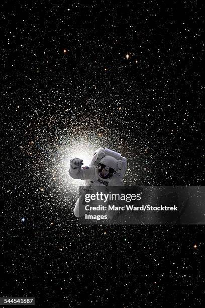 astronaut floating in deep space with large cluster galaxy in background. - eva stock pictures, royalty-free photos & images