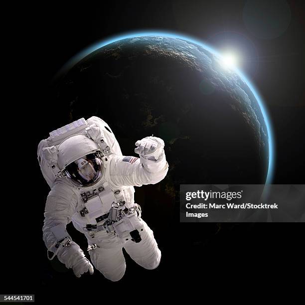 astronaut floating in space as the sun rises on an earth-like planet. - unrecognizable person photos stock illustrations