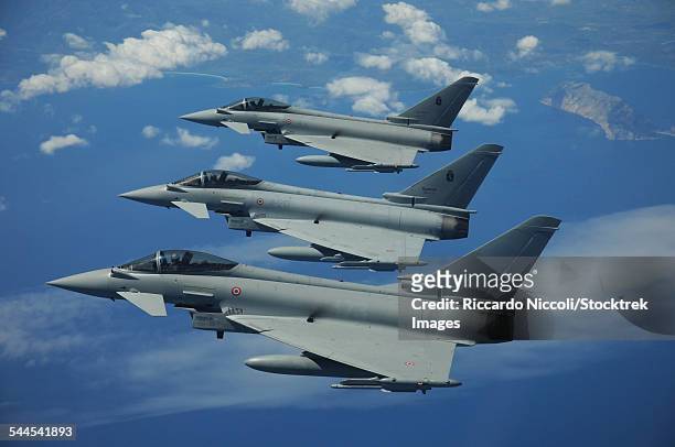 three italian air force eurofighter ef2000 typhoon aircraft in flight over the mediterranean. - eurofighter typhoon stock pictures, royalty-free photos & images