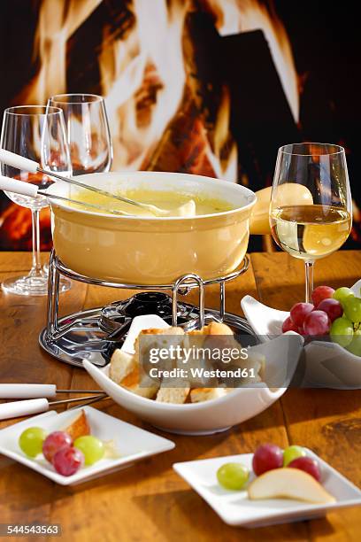 cheese fondue with bread and grapes - cheese fondue stock pictures, royalty-free photos & images