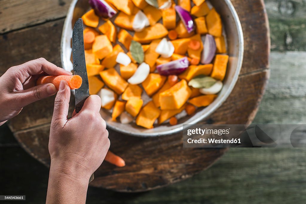 Hand cutting pumpkin