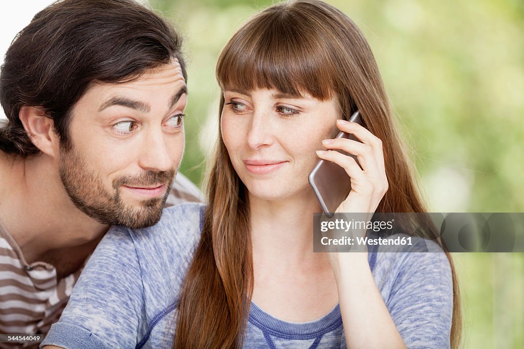 Man looking at woman on cell phone