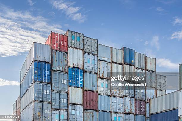 germany, hamburg, stacked shipping containers at harbour - container stock-fotos und bilder