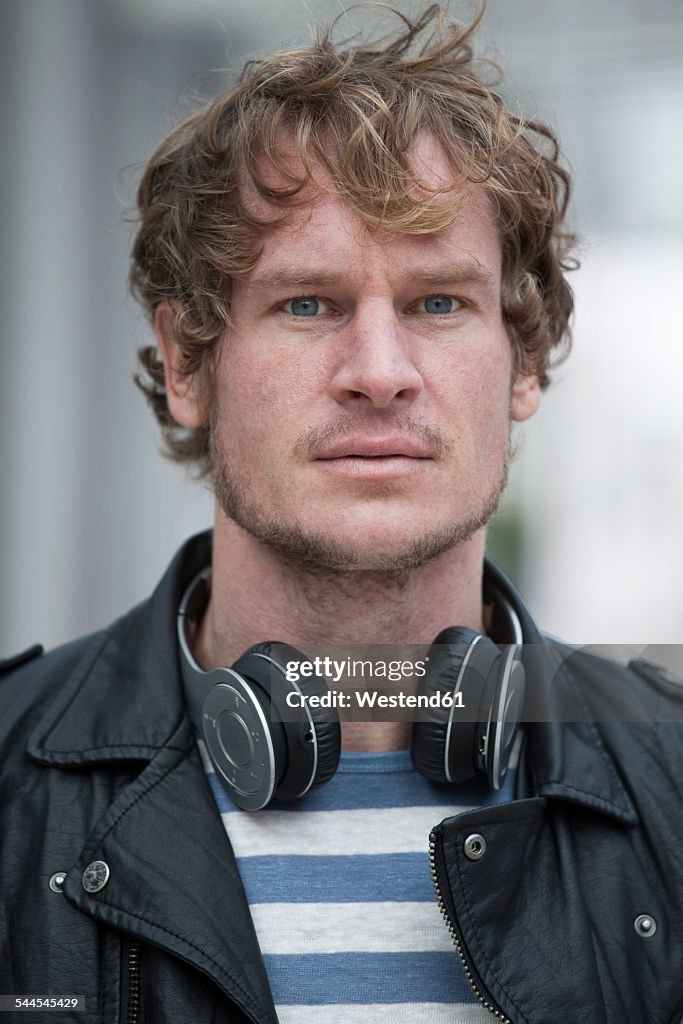 Portrait of serious looking man with headphones