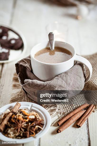 bowl of masala chai with almond milk on jute and wood - chai tea stock pictures, royalty-free photos & images