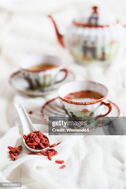 cup of green tea with dried goji berries, lycium barbarum - goji berry stock pictures, royalty-free photos & images