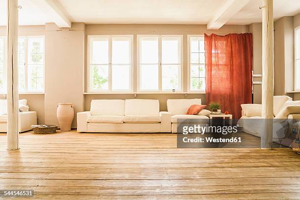 spacious living room with wooden floor - living room window stock-fotos und bilder
