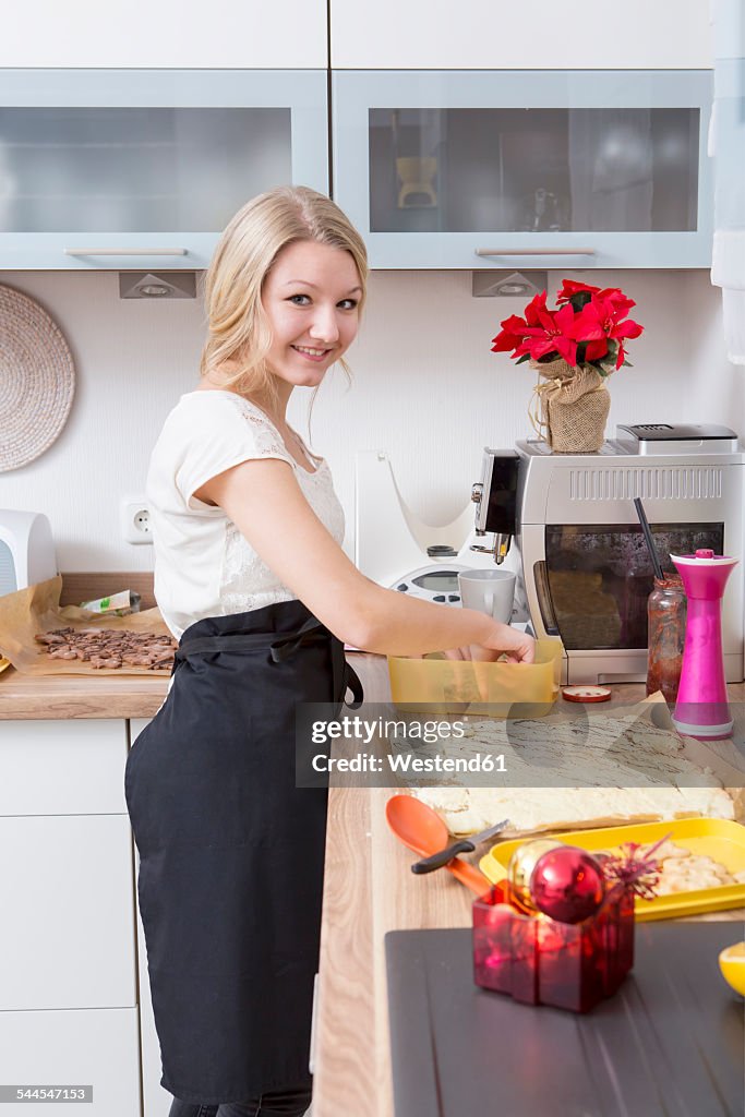 Teenage girl preparing Christmas cookies in a kitchen