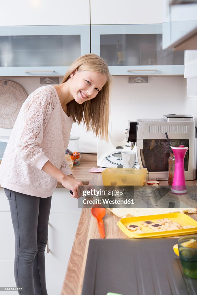 Girl preparing Christmas cookies in a kitchen