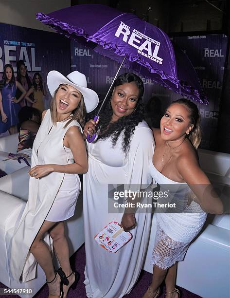 Jeannie Mai, Loni Love and Adrienne Bailon, co-hosts of the hit daytime talk show, "The Real," arrive at the ESSENCE / Warner Bros. Day Party at The...