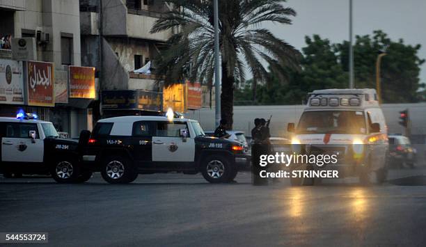 Saudi policemen stand guard at the site where a suicide bomber blew himself up in the early hours of July 4, 2016 near the American consulate in the...