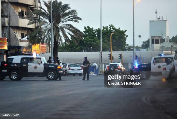 Saudi policemen stand guard at the site where a suicide bomber blew himself up in the early hours of July 4, 2016 near the American consulate in the...