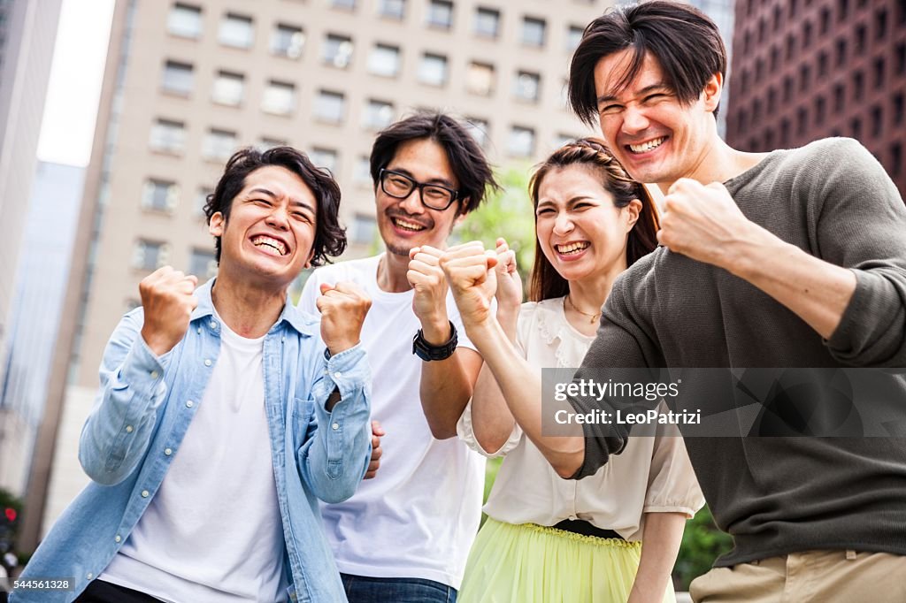 Team of friends cooperating together in Japan