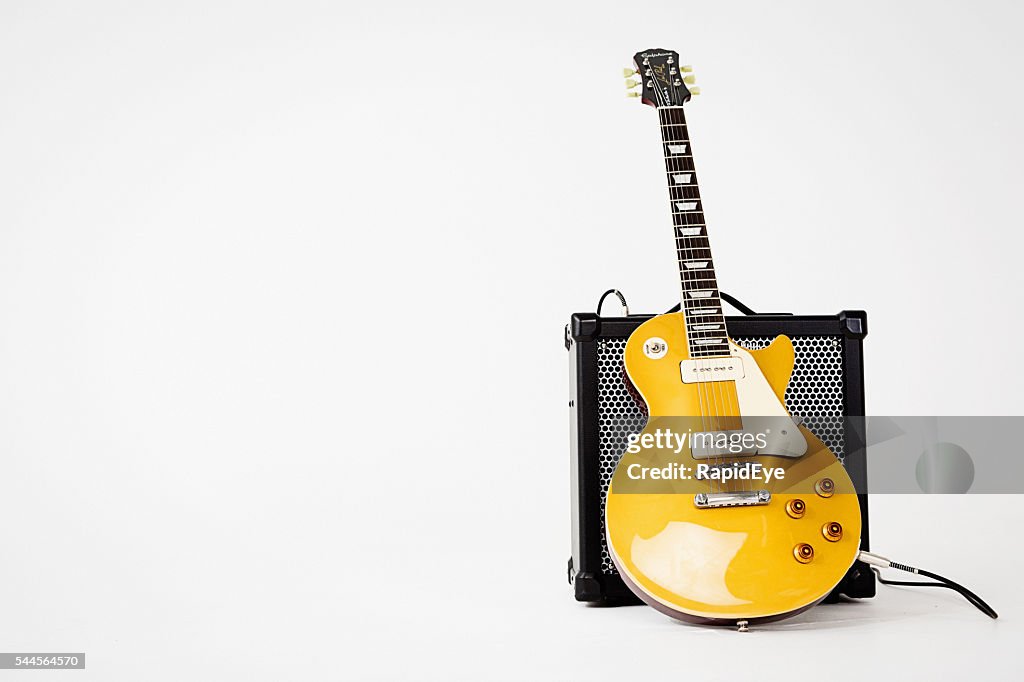 '56 Les Paul Pro electric guitar leaning on Roland amp