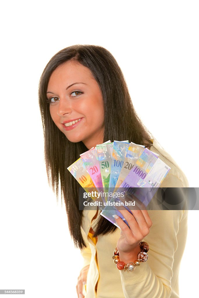 Young woman with Swiss Franc banknotes - 28.09.2009