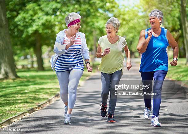 staying active is key to healthiness and happiness - active seniors group stock pictures, royalty-free photos & images