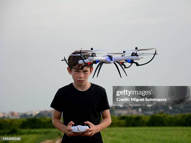 kid playing with his drone - drone kid fotografías e imágenes de stock