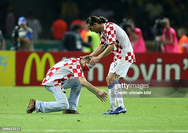 Deutschland, Berlin - FIFA Weltmeisterschaft 2006 WM; Fussballspiel: Brasilien - Kroatien / Kroatischer Fan Flitzer will Dado Prso die Füsse kuessen