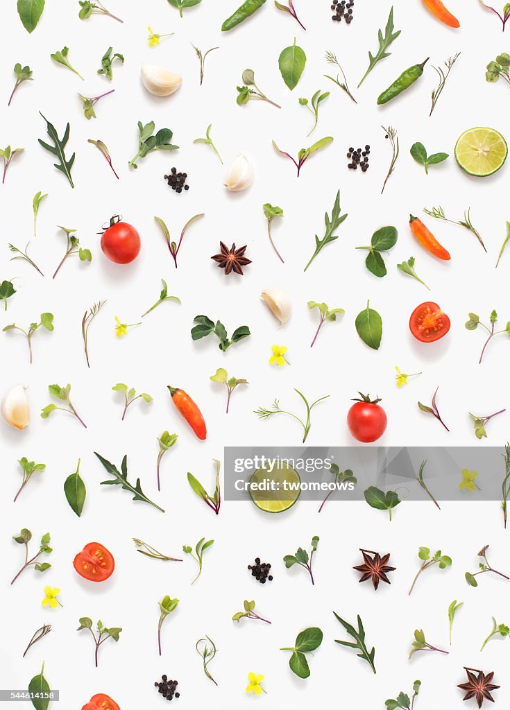 Flat lay fresh vegetables, herbs and spices on white background.