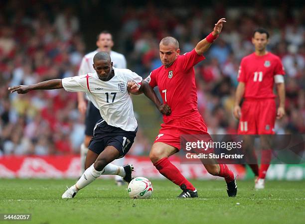 Wales midfielder Carl Fletcher battles with Jermaine Defoe of England during the Fifa World Cup 2006 Qualifying Group Six Match between Wales and...