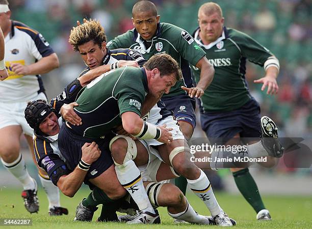 Michael Collins of Irish is tackled by Richard Parks and Scott Morgan of Leeds during the Guinness Premiership match between Leeds Tykes and London...