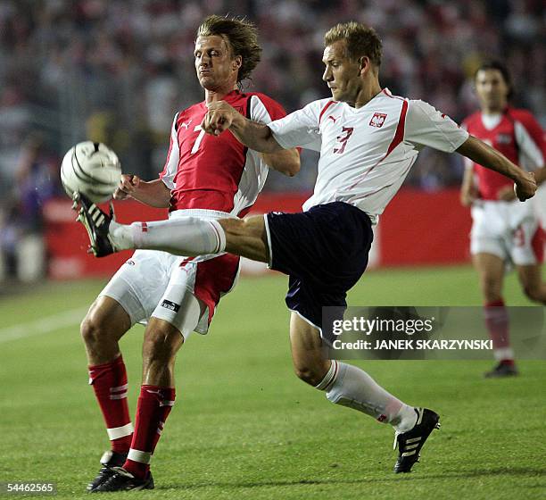 Markus Schopp from Austria challenges for the ball with Tomasz Rzasa from Poland during the World Cup 2006 qualifying match between Poland and...