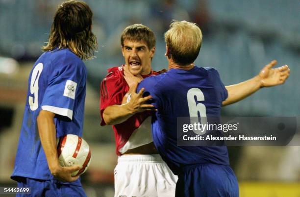 Sebastian Deisler of Germany tussles with Miroslav Karhan and Marian Had of Slovakia during the friendly match between Slovakia and Germany at the...