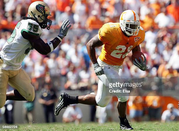 Gerald Riggs Jr. #21 of Tennessee carries the ball as Marcus Mark of UAB defends in the second half on September 3, 2005 at Neyland Stadium in...