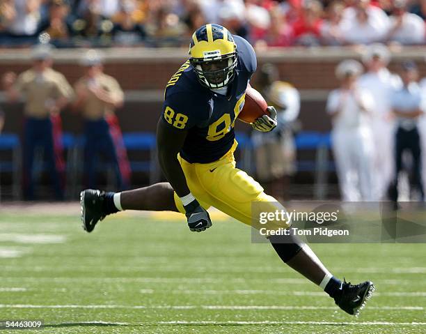 Tim Massaquoi of Michigan looks for room to run after catching a pass against Northern Illinois at Michigan Stadium on September 3, 2005 in Ann...