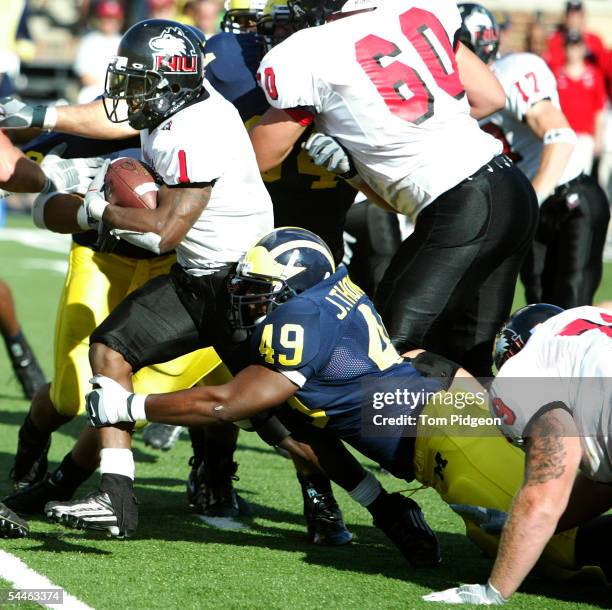 John Thompson of Michigan tackles Garrett Wolfe of Northern Illinois at Michigan Stadium on September 3, 2005 in Ann Arbor, Michigan. Michigan won...